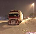 Vrachtwagen van Vroegindewey op een besneeuwde weg in Scandinavië